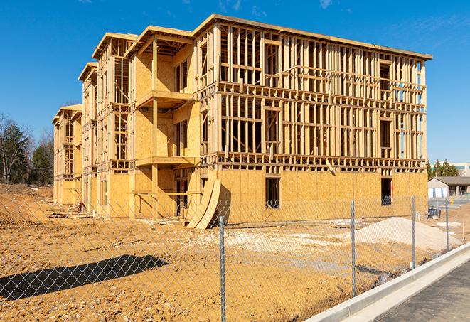 construction zone secured with a temporary fence, marked with warning signs in Duarte, CA